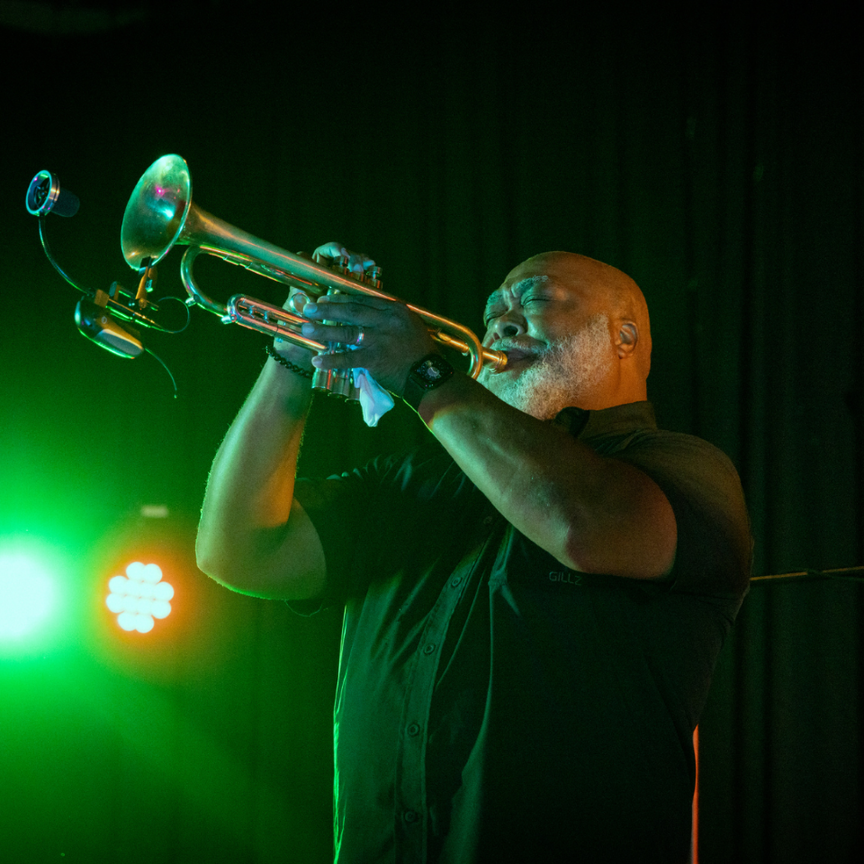 A man playing trumpet during a concert.