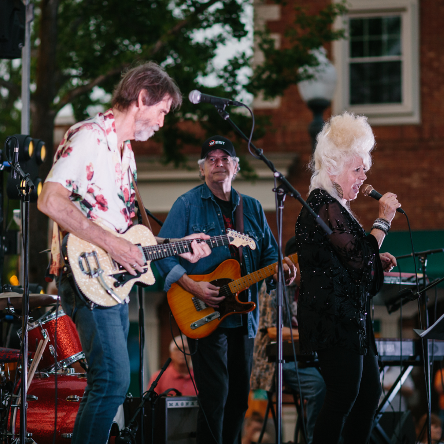 Three long-time Muscle Shoals musicians play & sing on an outdoor stage.