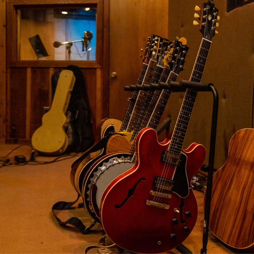 Guitars lined up in a recording studio.